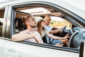 male teen driver with two teen passengers, including a female.