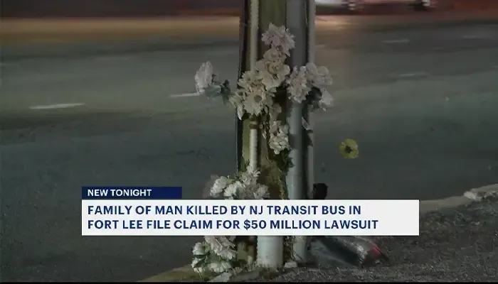 Flowers are on a pole on the side of the road