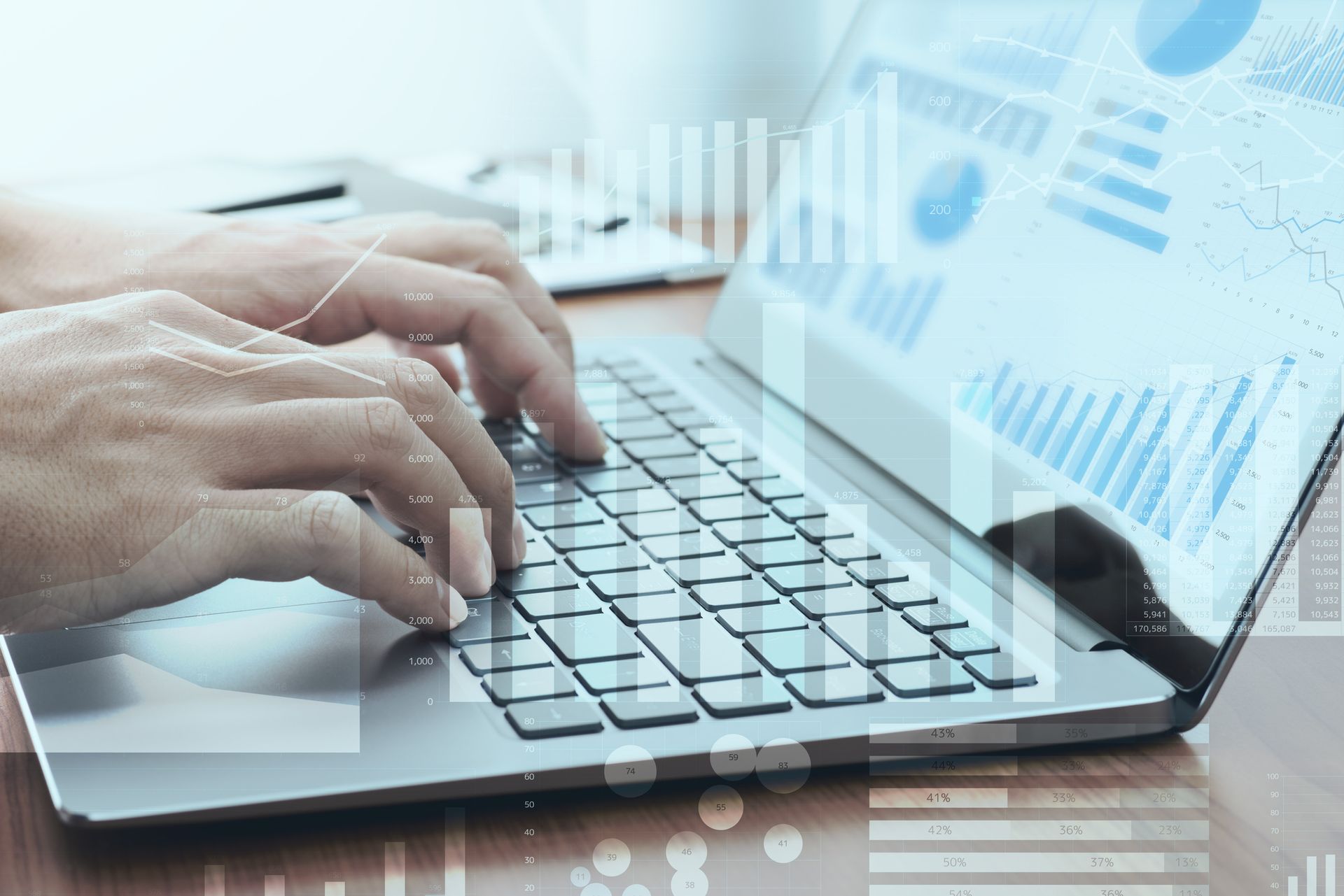 Person typing on a laptop with graphs, showcasing managed IT services in Banner Elk, NC.