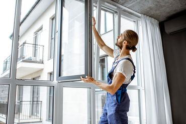 Man Installing New Window — Dayton OH — Gem City Home Improvements