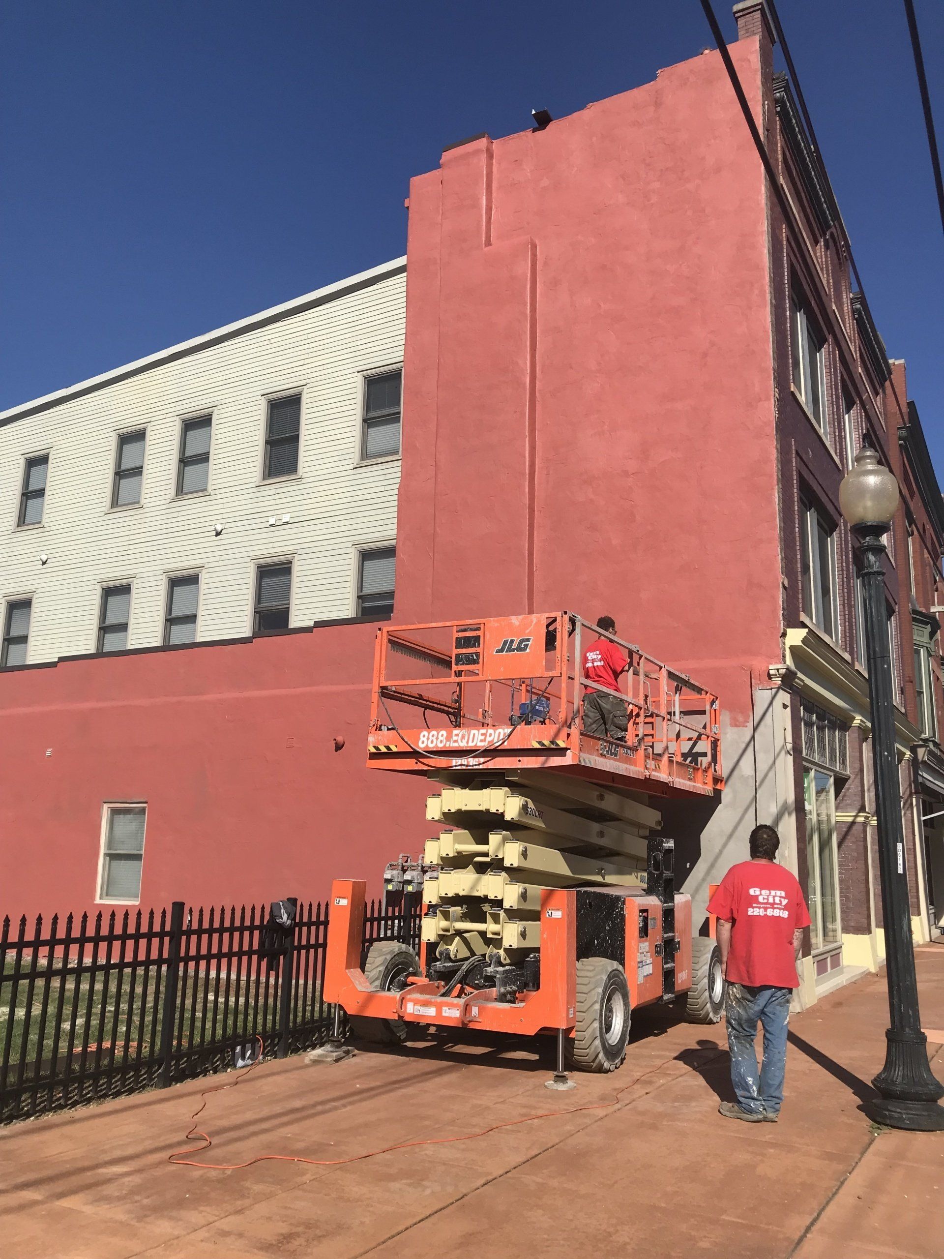 Hand with a Spatula in the Process of Leveling the Raw Plaster — Dayton OH — Gem City Home Improvements