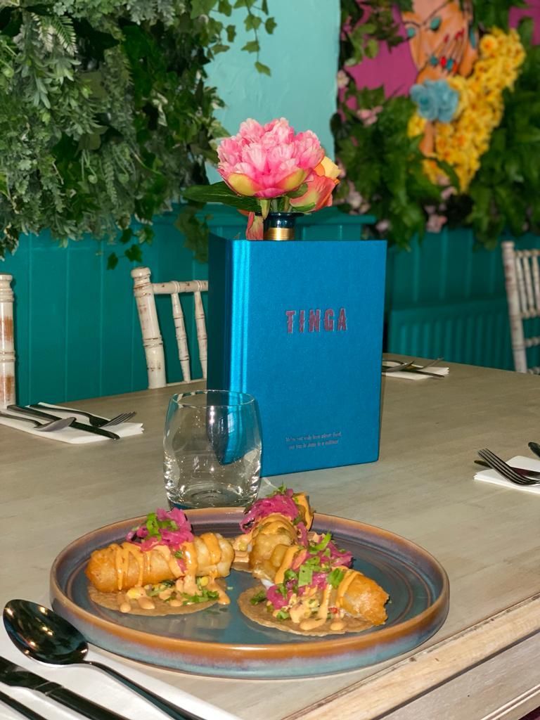 A plate of food is sitting on a table next to a menu.