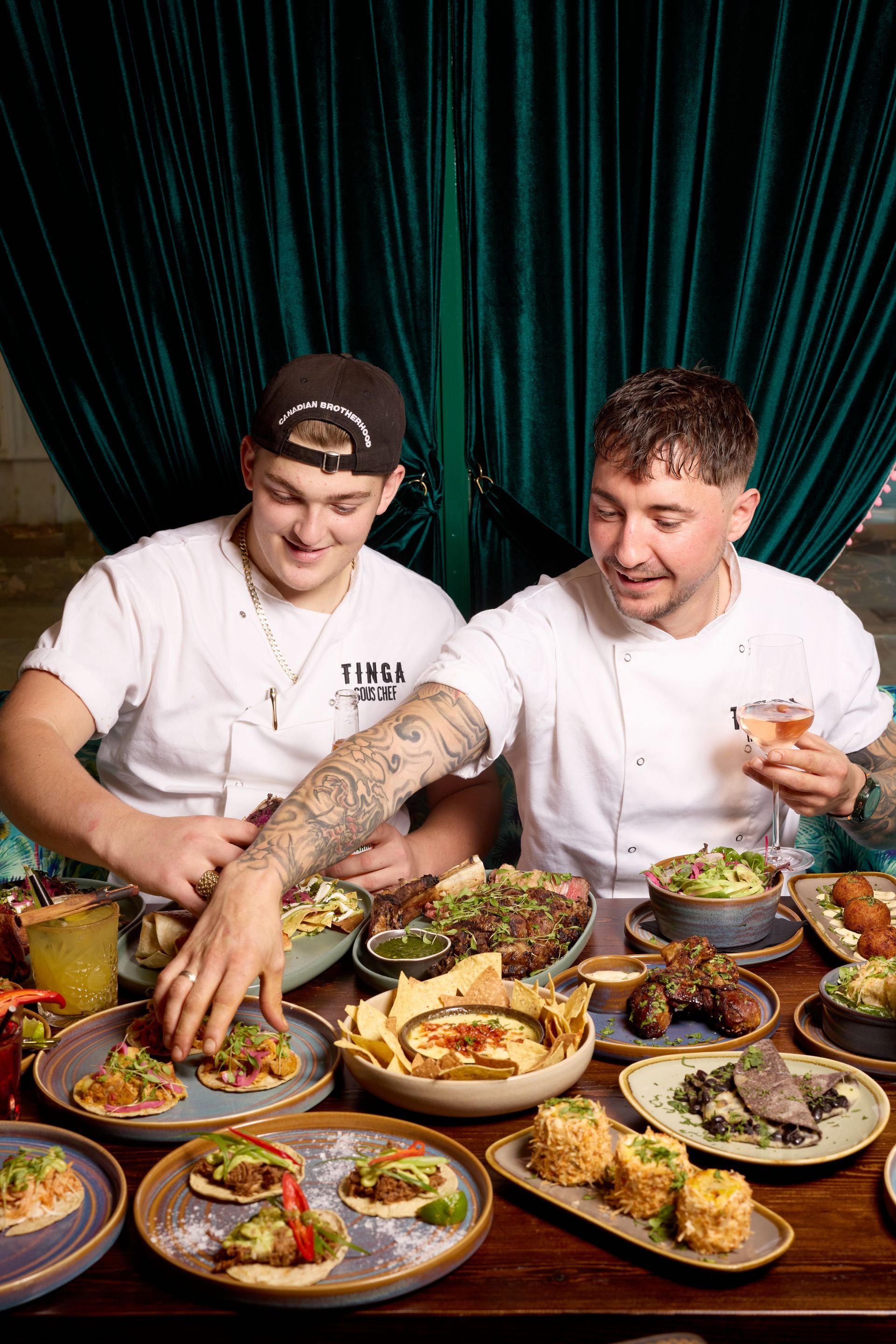 A man is holding a glass of beer in front of a group of people.