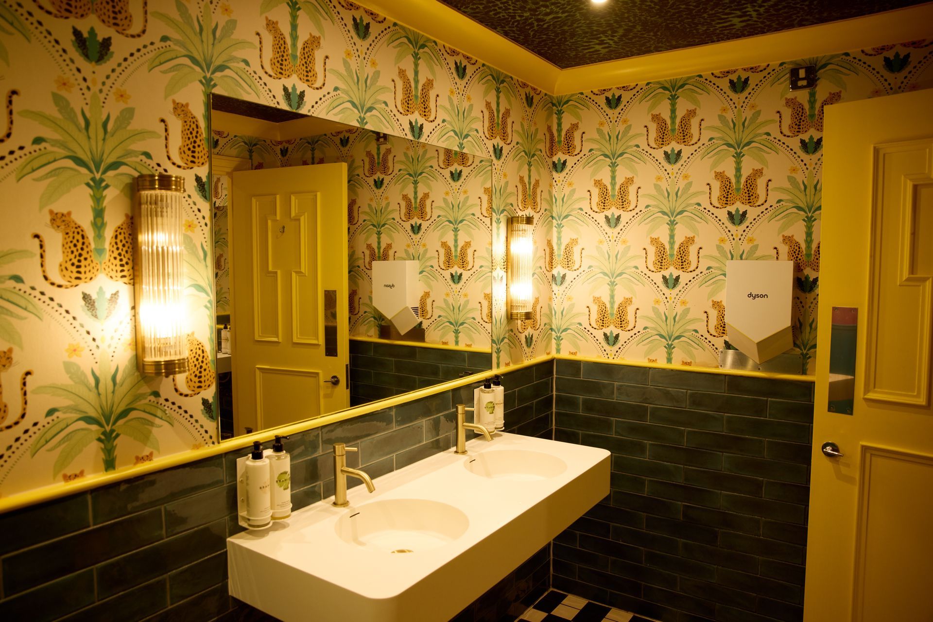 A mural of a skeleton wearing a top hat and flowers on a wall.