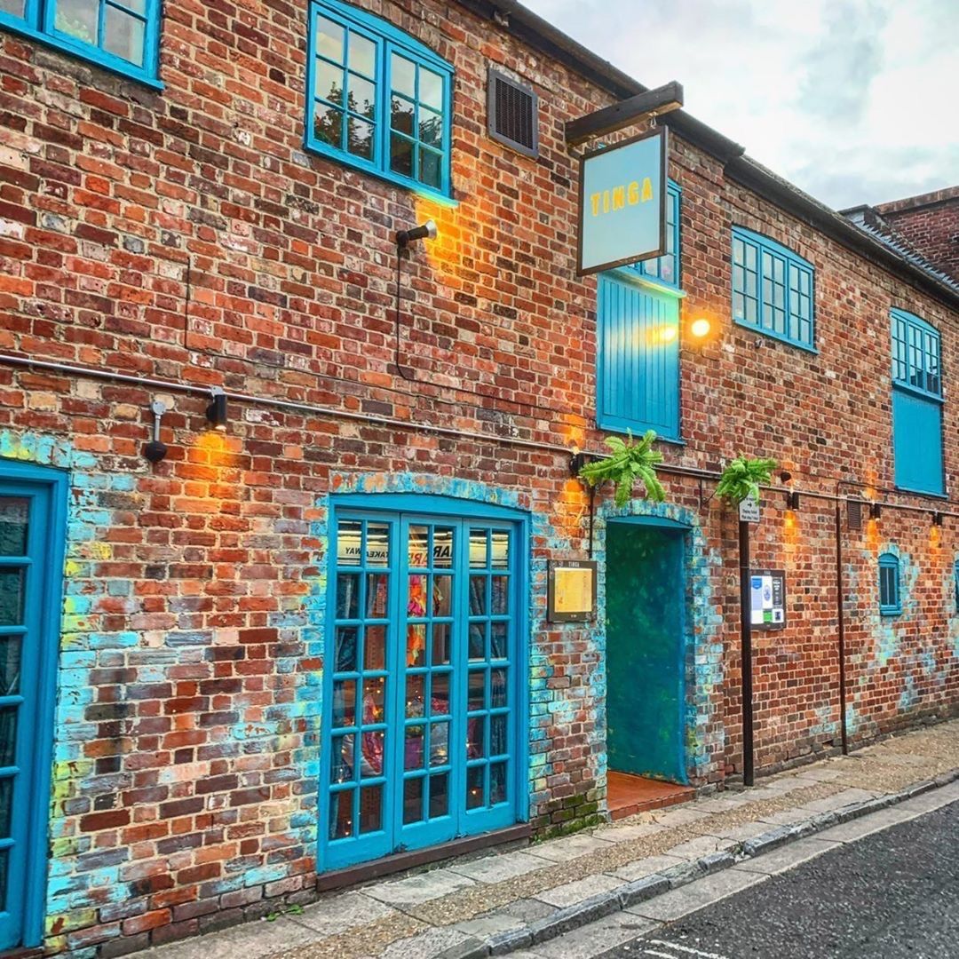 A brick building with blue windows and doors