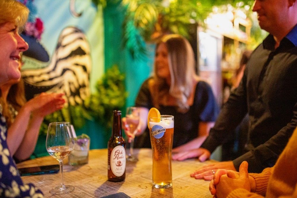 A group of people are sitting at a table with drinks.