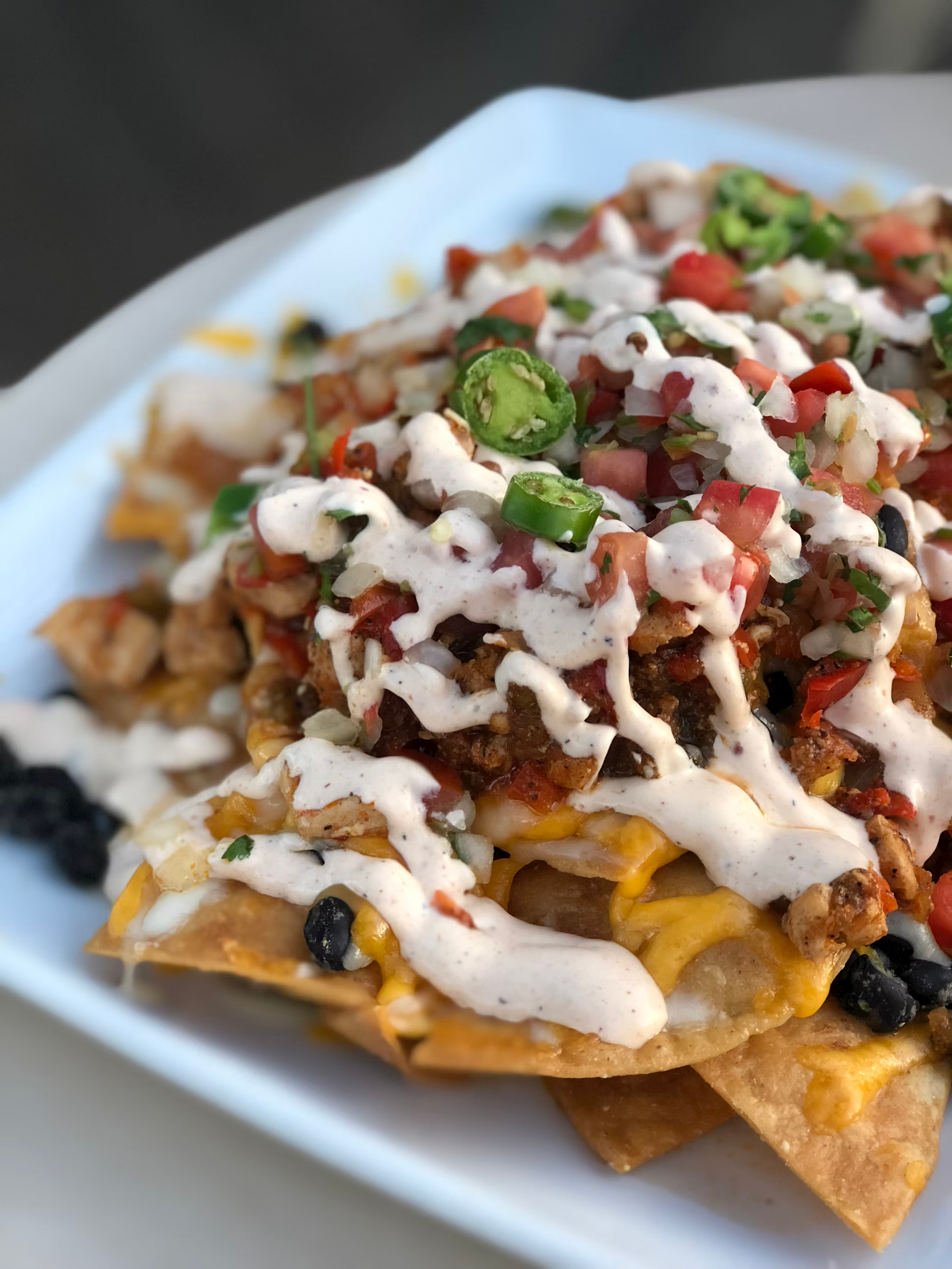 A close up of a plate of nachos on a table