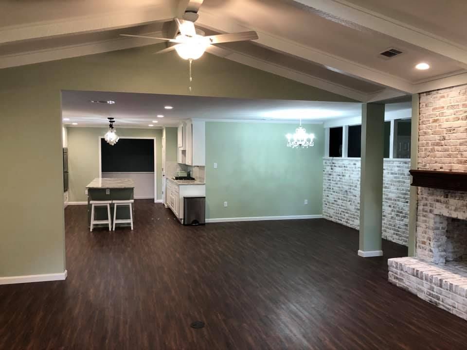 A living room with a ceiling fan and a fireplace