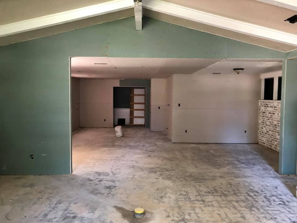 A large empty room with a ceiling that is being remodeled.