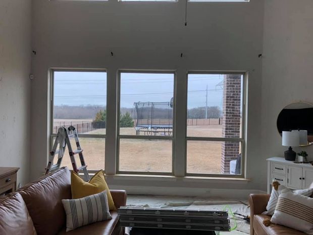 A living room with a couch , coffee table , and ladder.