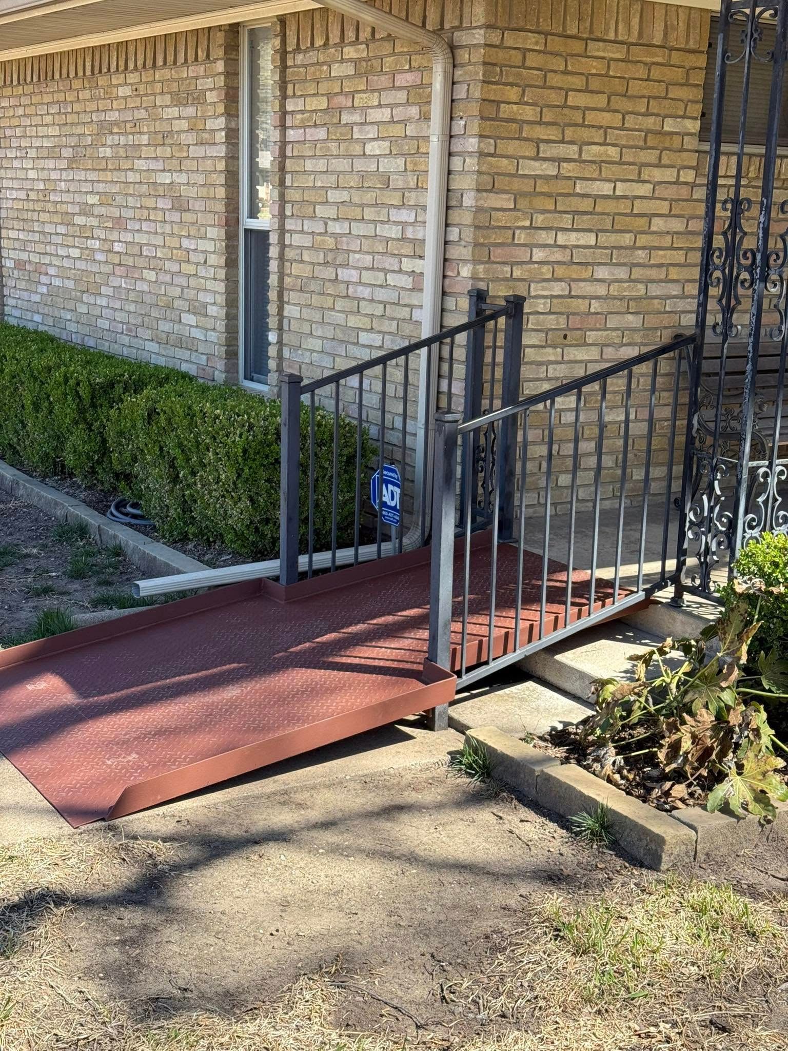 A ramp leading to the front door of a brick house.