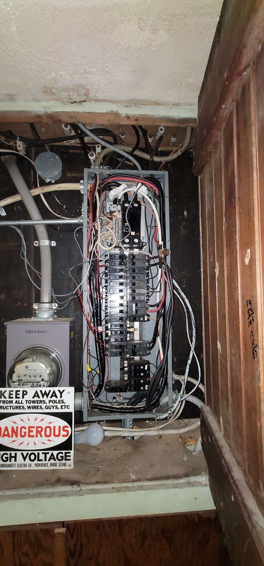 There is a sign on the wall that says `` keep away from dangerous electrical equipment ''.