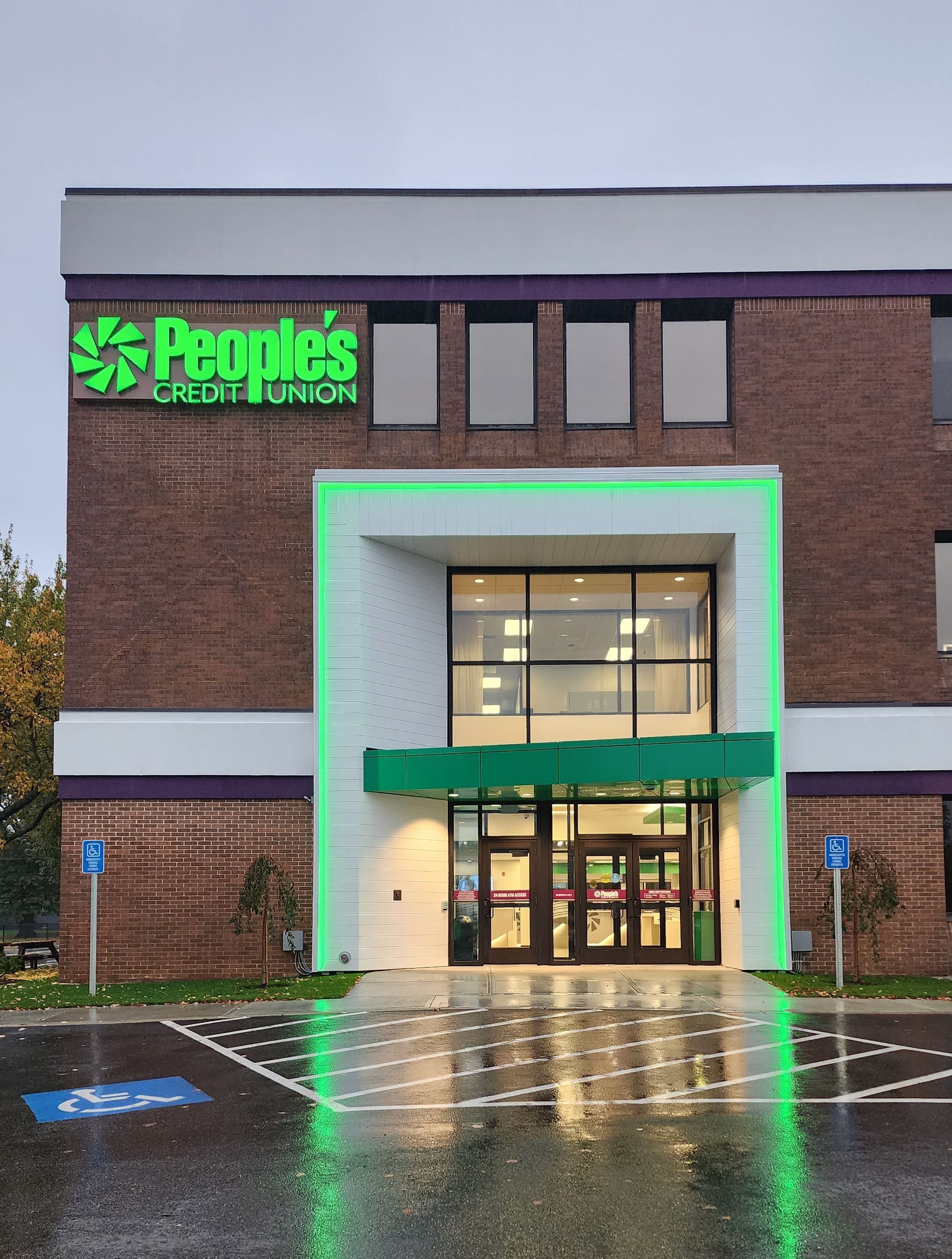 A people 's credit union building with a green entrance