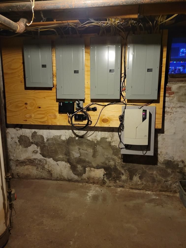 A basement with a lot of electrical panels on the wall.