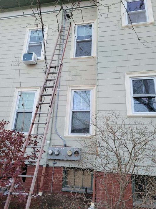 A ladder is attached to the side of a building.