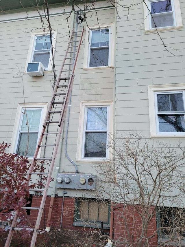 A ladder is attached to the side of a building.