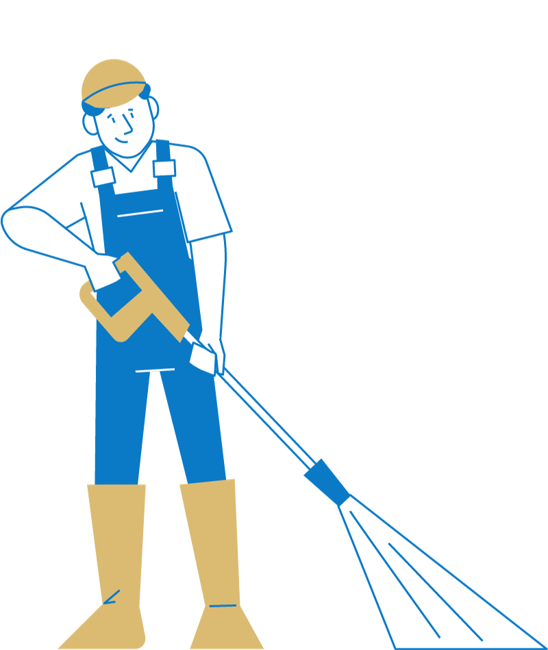 A man in overalls is holding a high pressure washer.