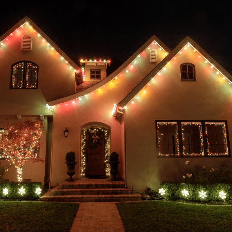 A house with christmas lights on it at night