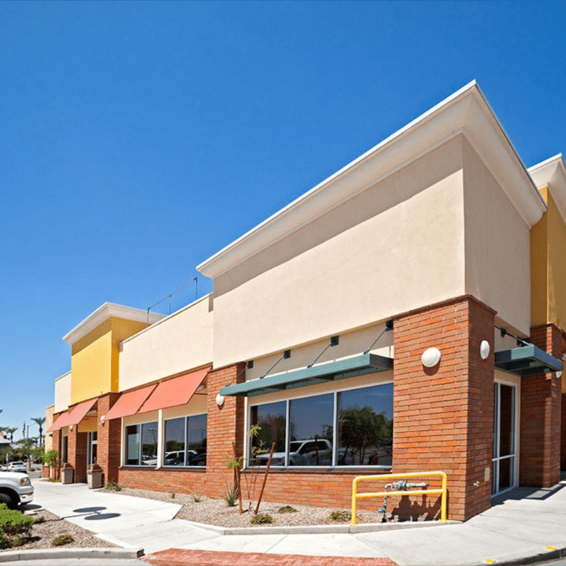 A brick building with a lot of windows and awnings