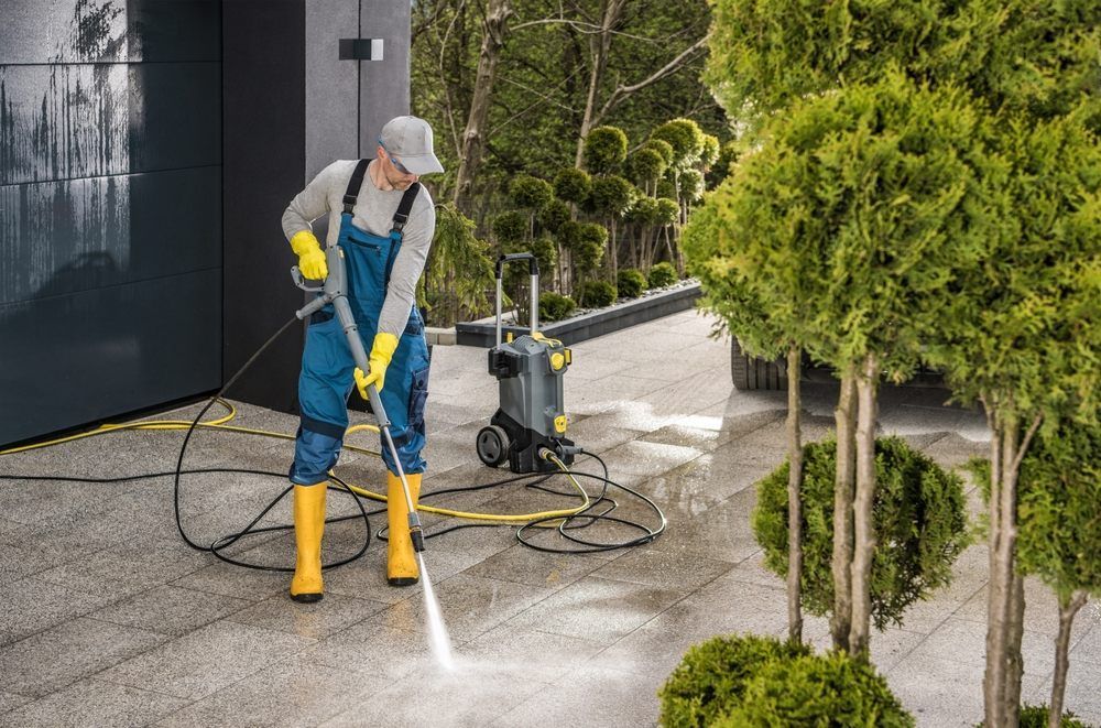 AllTex Home & Commercial Services.  Man Cleaning His House Surroundings with a Pressure washer.