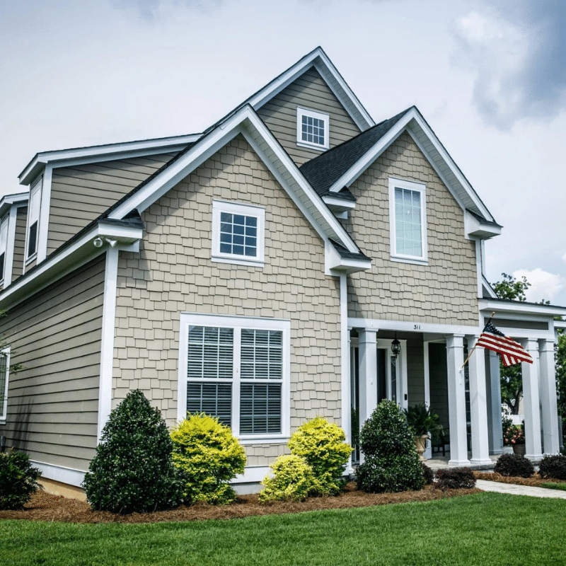 A large house with a flag on the front porch