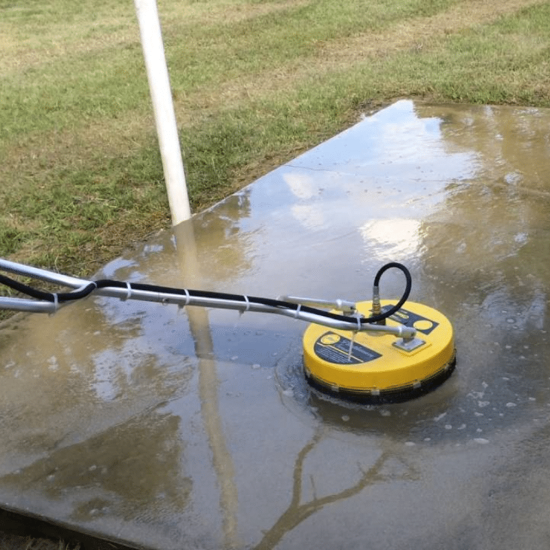 A yellow device is sitting on a wet concrete surface