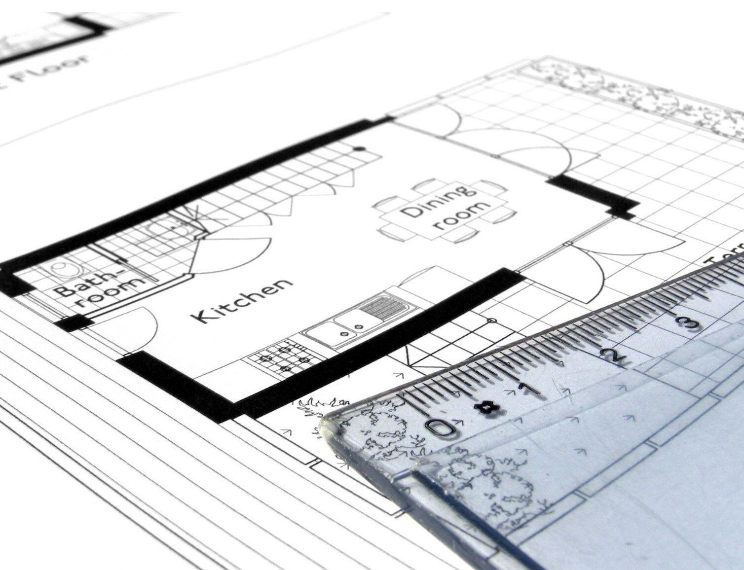 2D plan drawing of kitchen and dining room with ruler on top of drawing