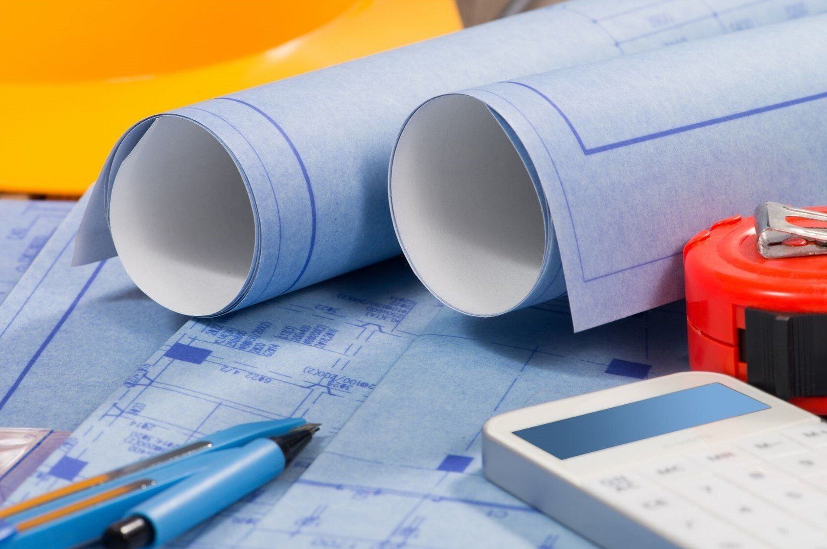 Architectural drawings rolled up on desk