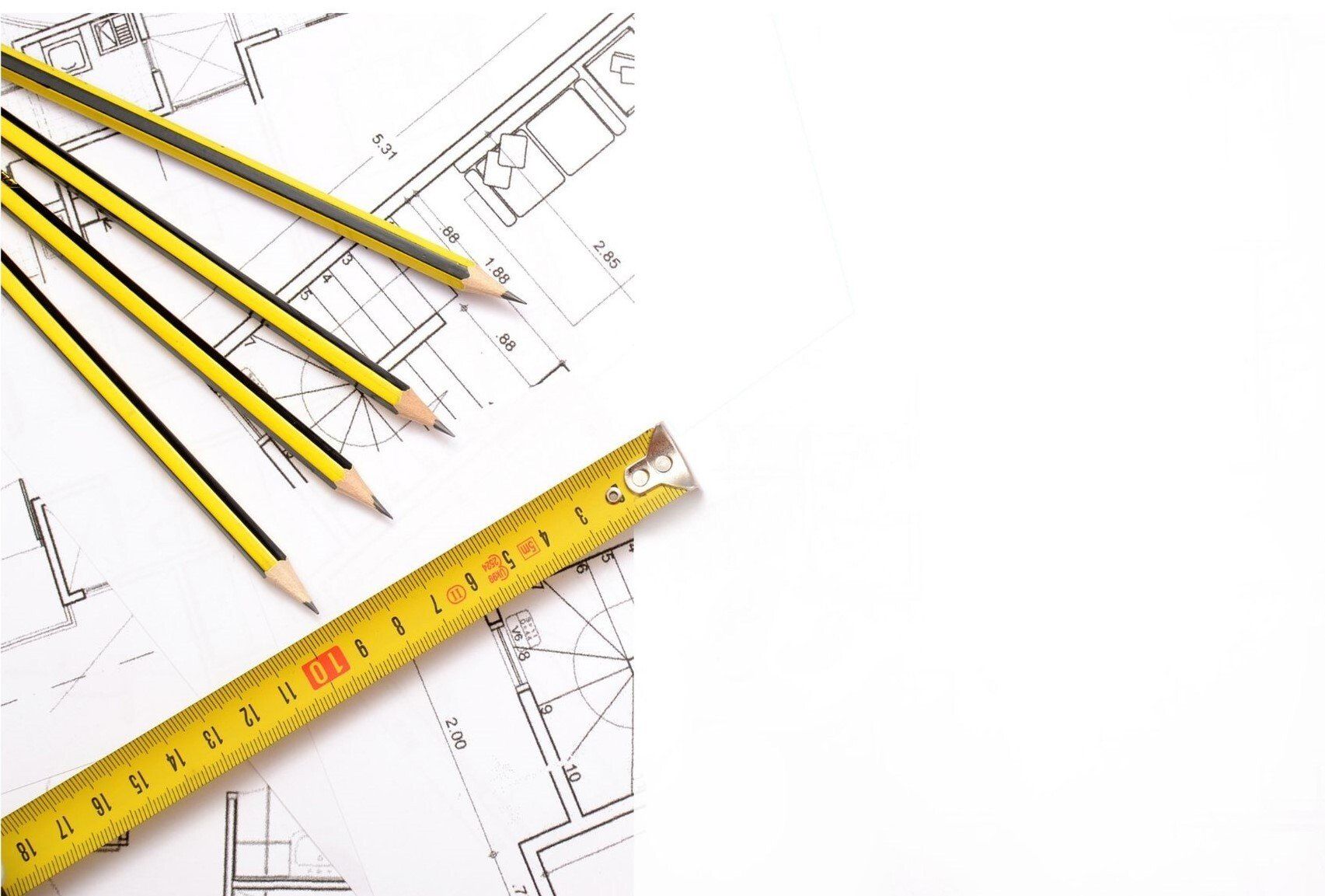 Architectural drawing with measuring tape and pencils on top