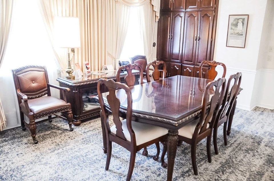 A dining room with a table and chairs in it