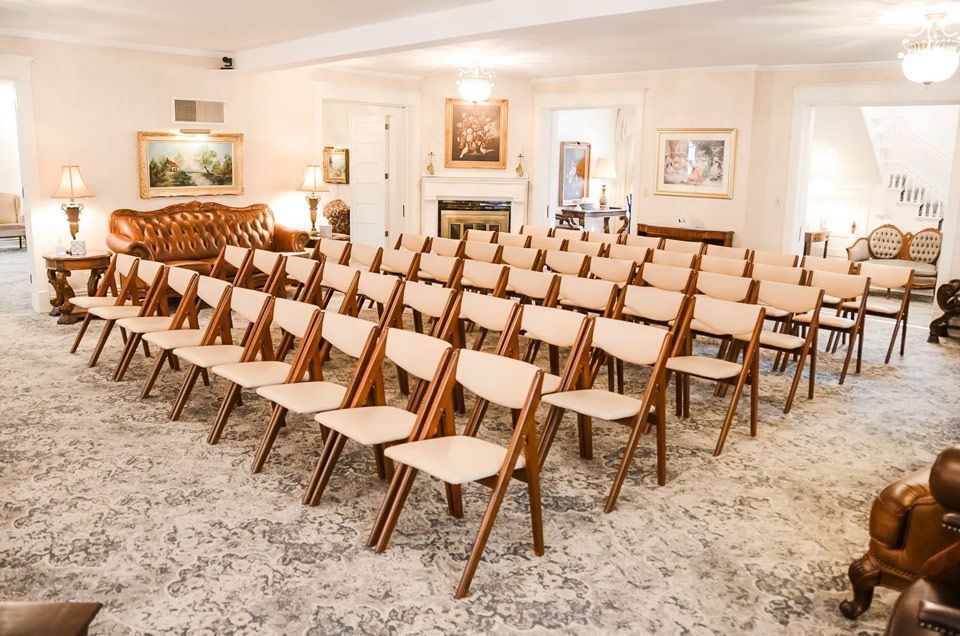 A room filled with rows of chairs and a clock.