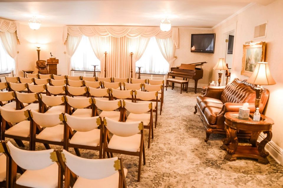 A room with rows of chairs and a piano in it.