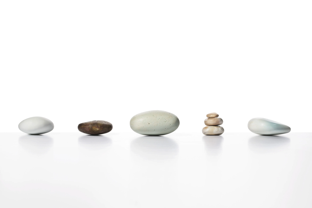 A row of rocks sitting on top of each other on a white surface.
