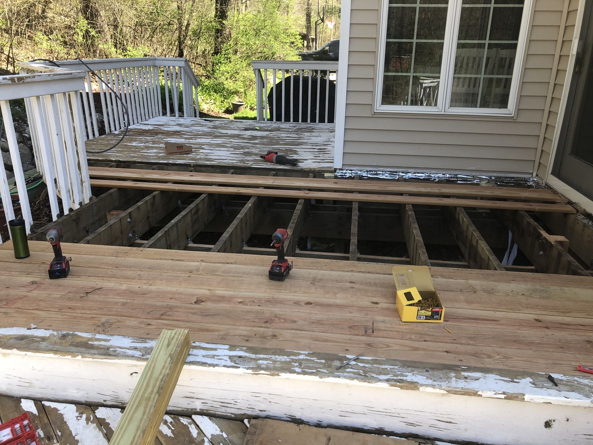 A wooden deck is being built on top of a house.