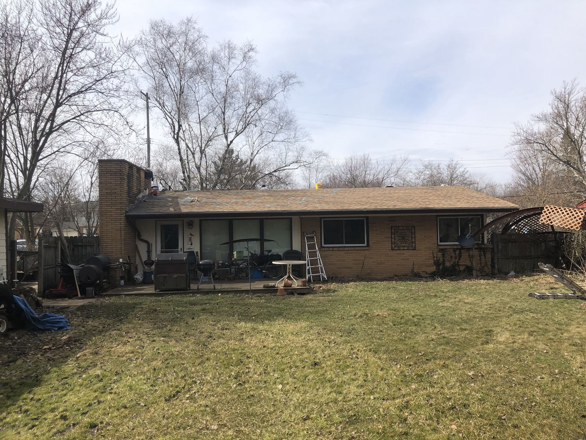 A brick house with a large lawn in front of it.