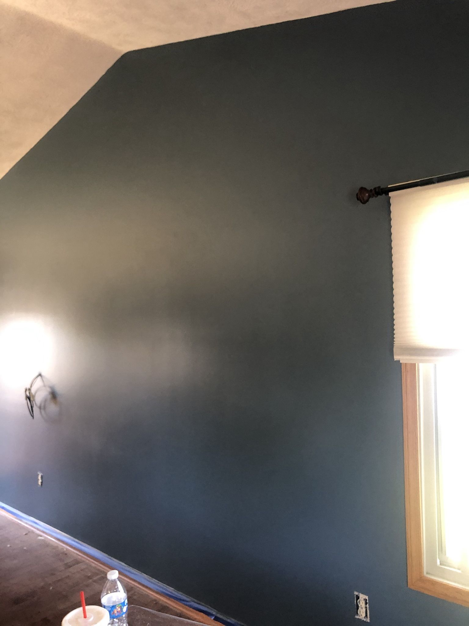 A room with a blue wall and a window.