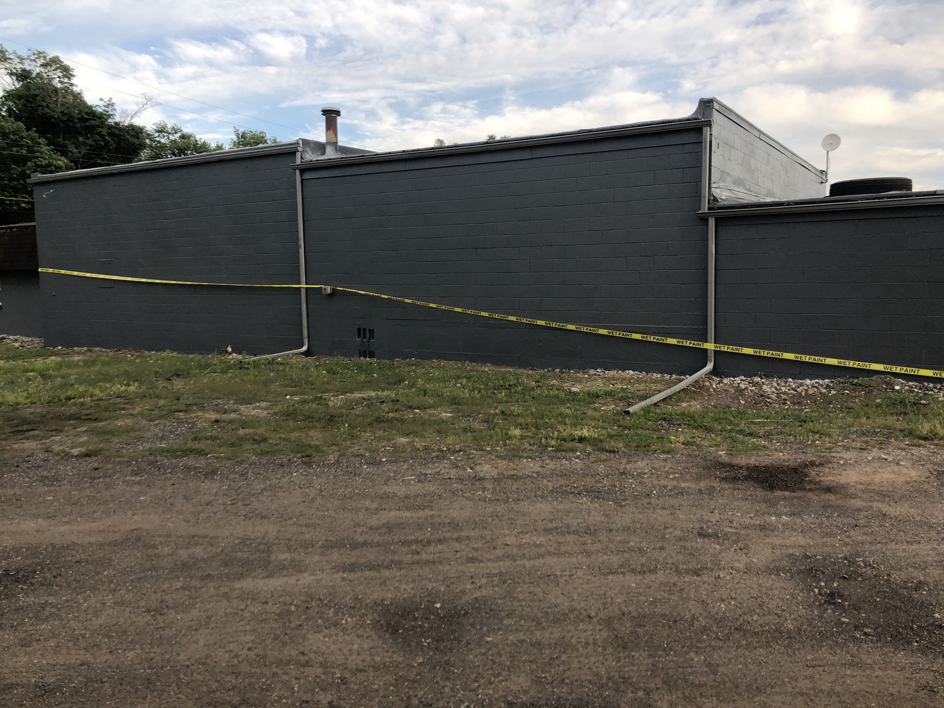 A brick building with a yellow tape around it