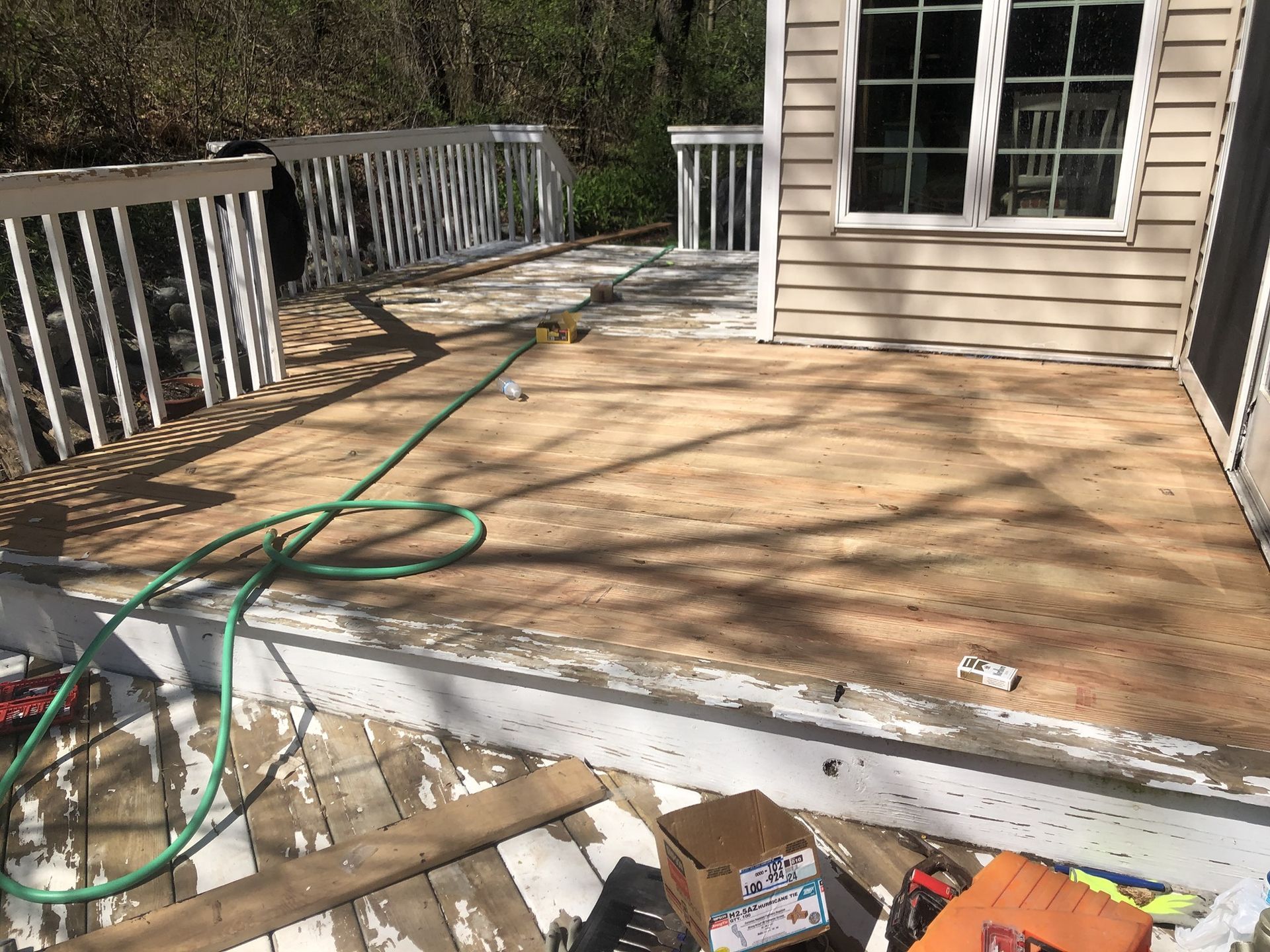 A deck with a hose attached to it is being remodeled.