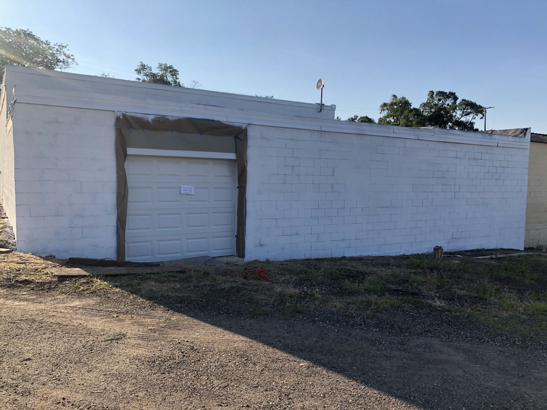 A white brick building with a garage door
