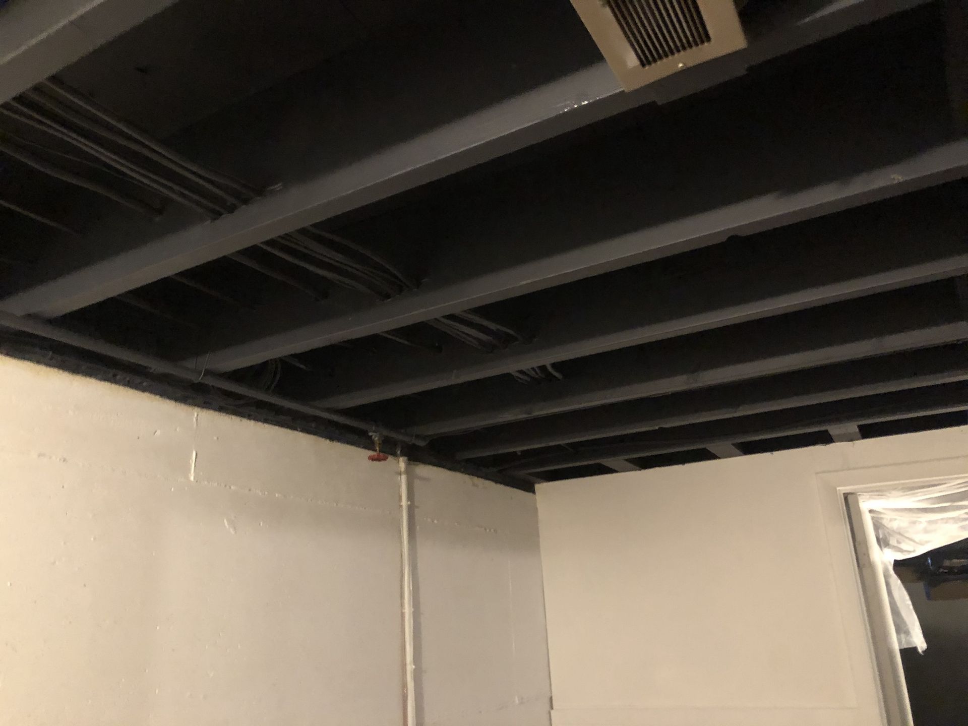 A room with a black ceiling and white walls