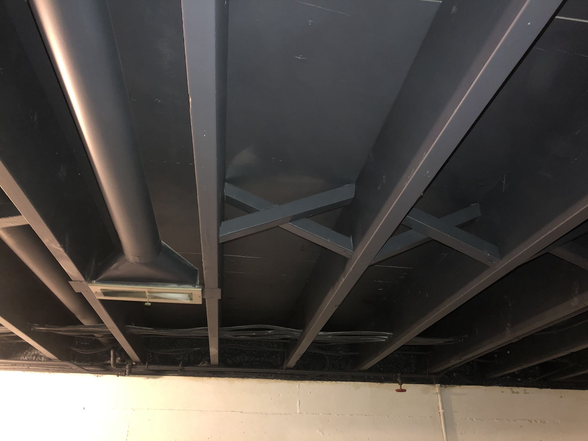 A close up of a ceiling with a lot of metal beams