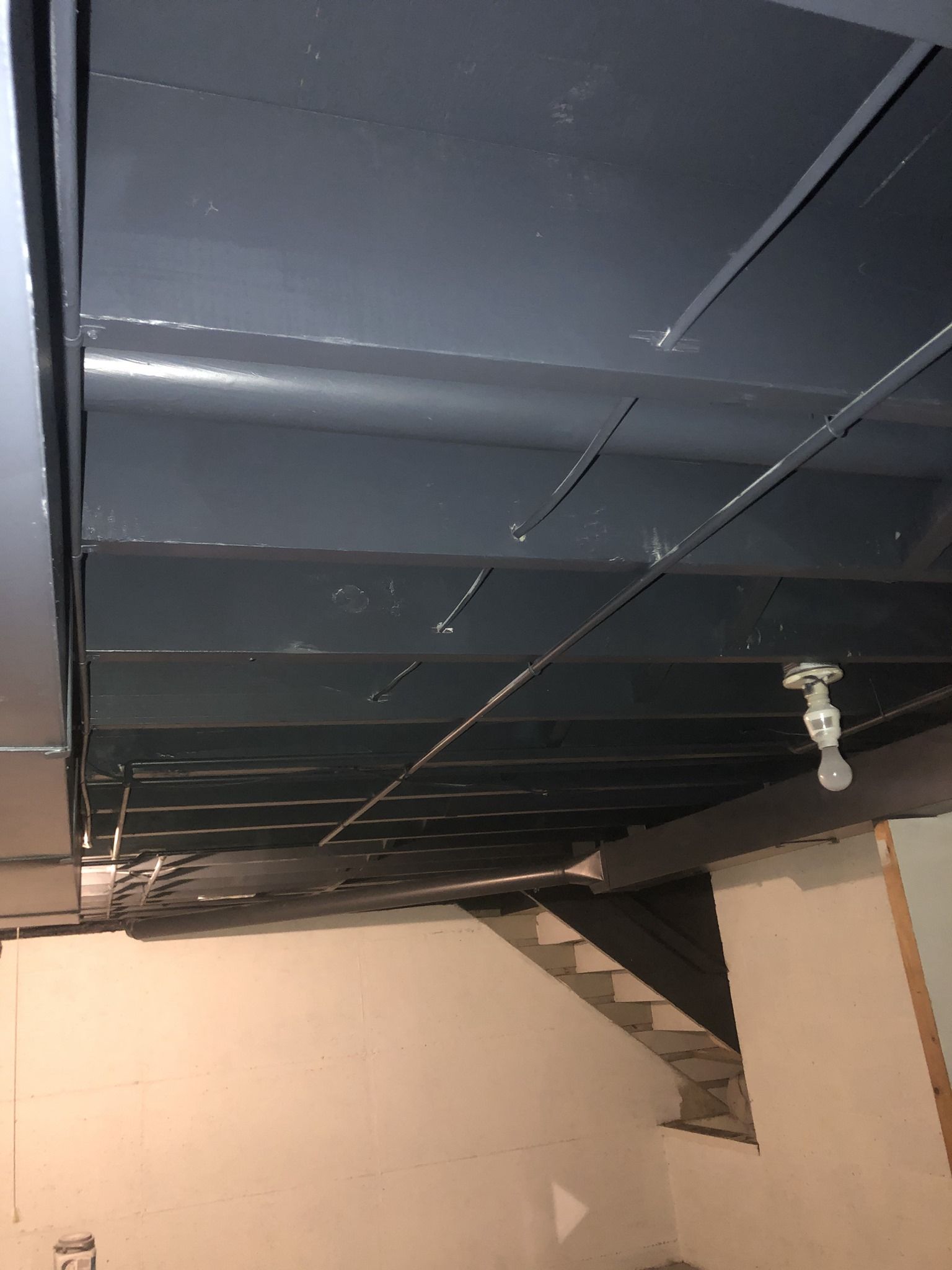 A ceiling with a ceiling fan hanging from it in a room.