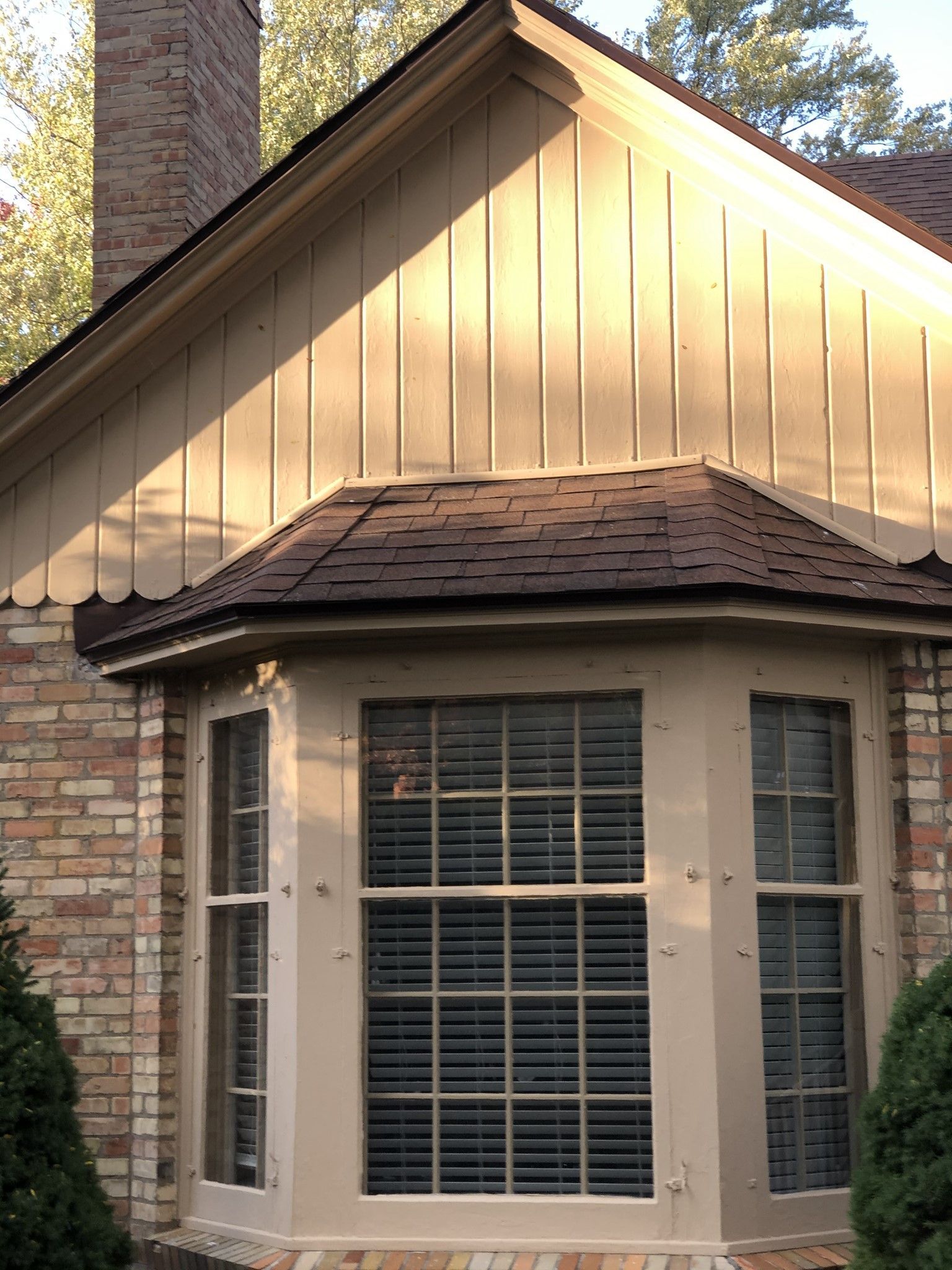 A house with a bay window and a chimney