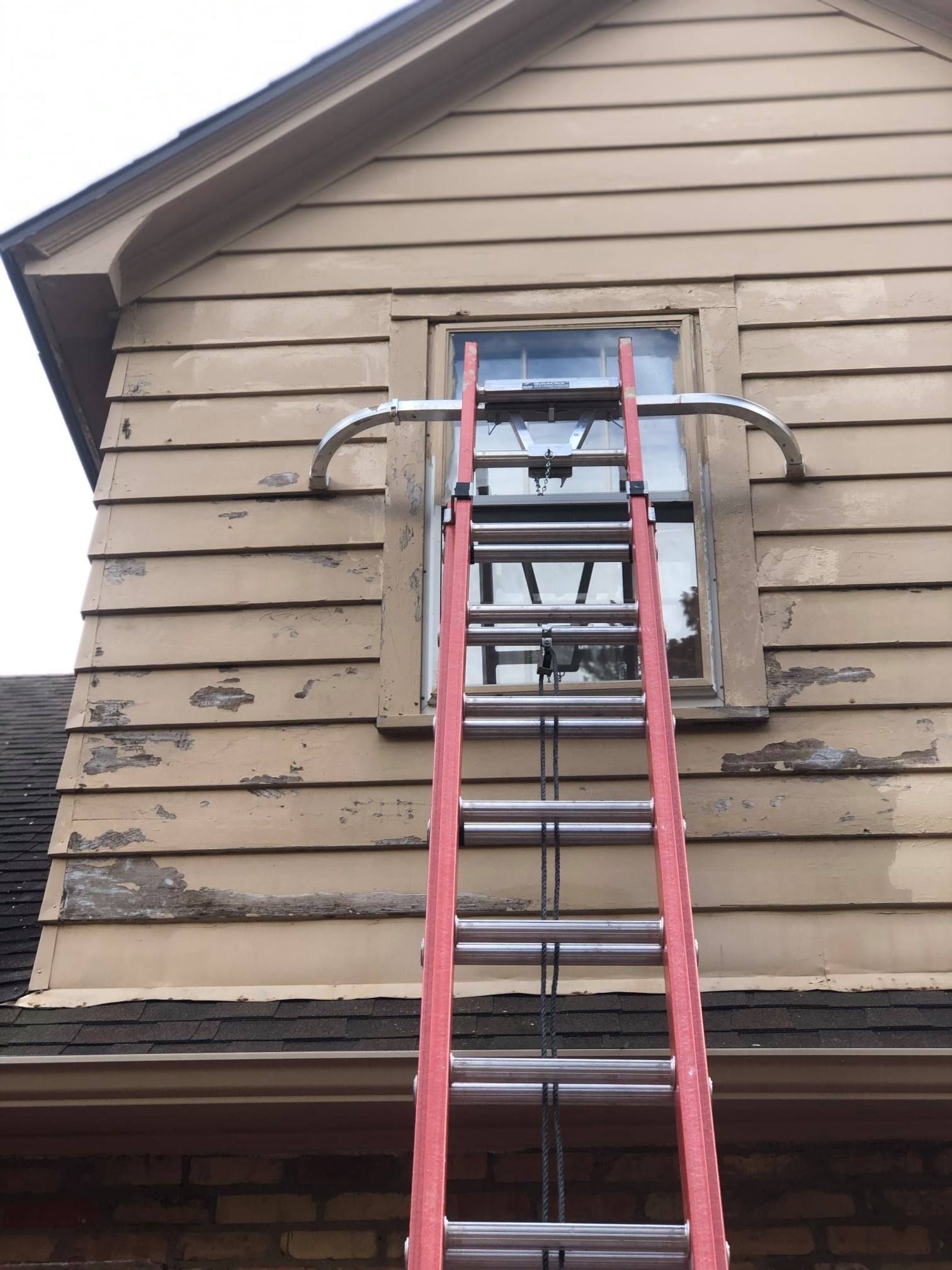 A ladder is attached to the side of a house