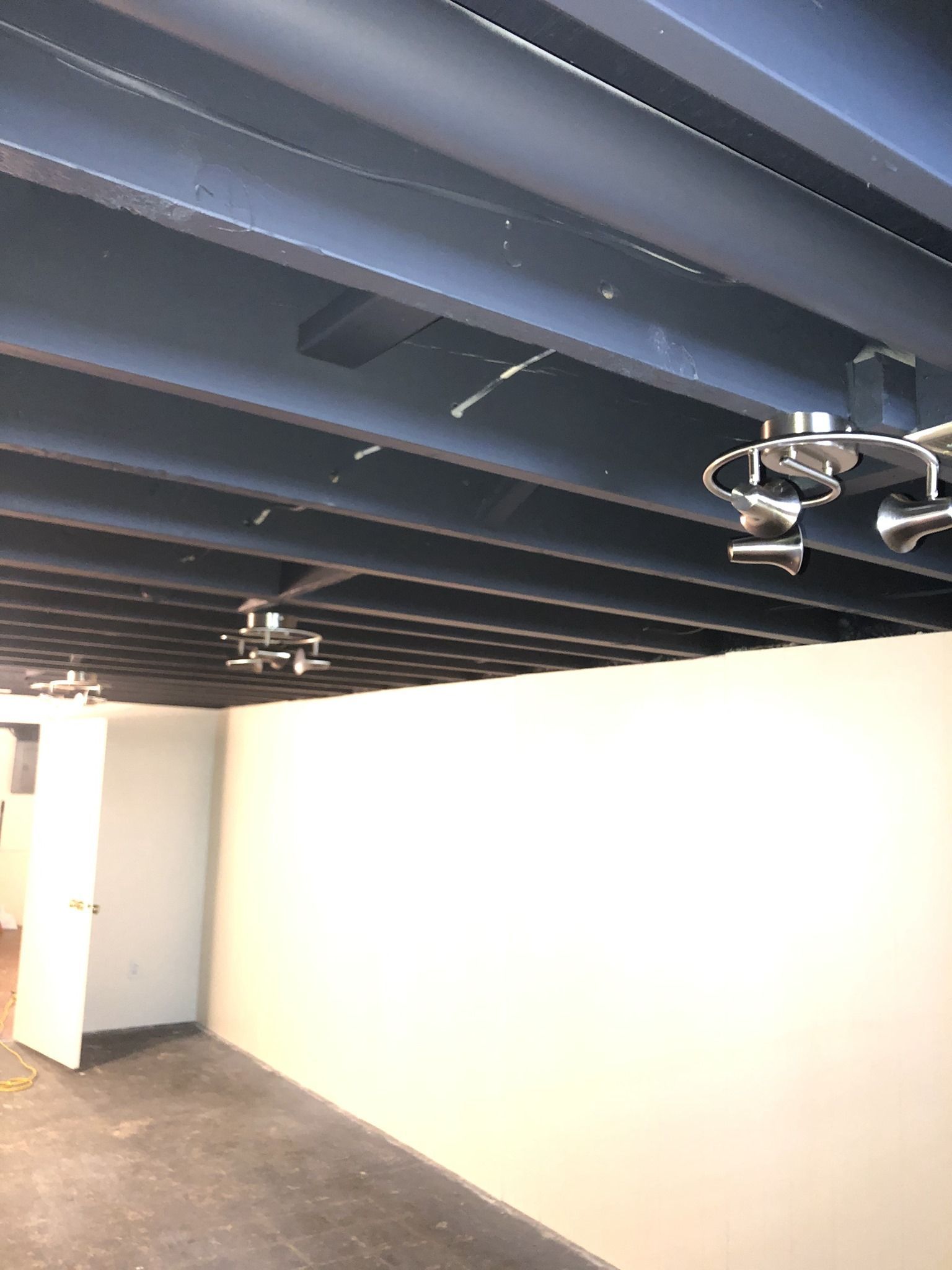 A room with a blue ceiling and a white wall.