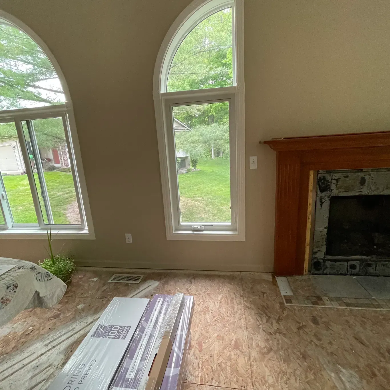 A living room with a fireplace and a lot of windows.