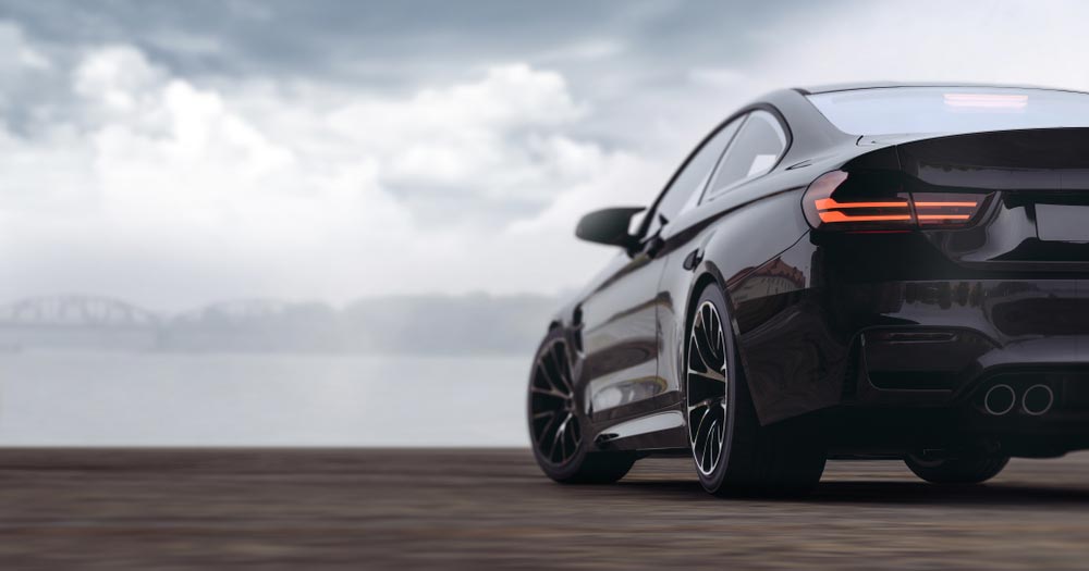 A Black Car is Parked on a Wooden Dock Next to a Body of Water — Rite Price Tyres In Berkeley Vale, NSW