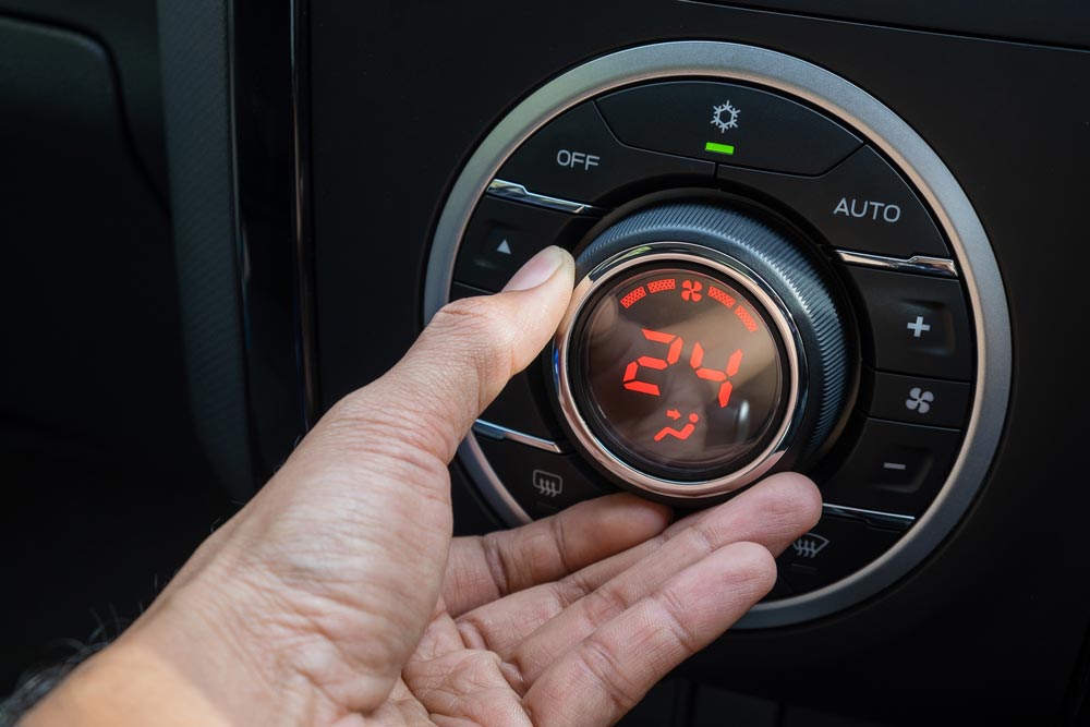 A Person is Adjusting the Temperature of the Air Conditioner in a Car — Rite Price Tyres In Berkeley Vale, NSW