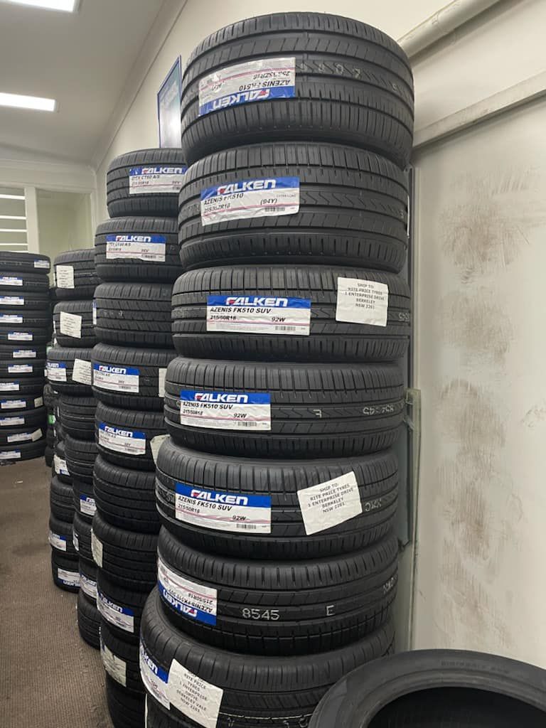 Towers of New Tires Stacked in a Shop, Ready for Sale.