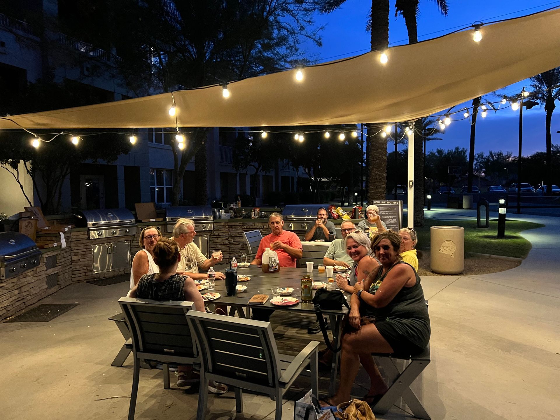 Yoga retreat group sitting outside eating group dinner